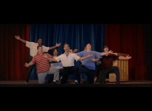 Meister helps save the show by using the football team as background dancers, with comical results