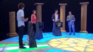 The Russo Family competition is set up like a television game show, with Justin taking an early lead