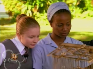 Mahree sits with Flora, learning about the story of the weaver bird