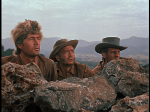 Davy, Georgie, and Thimblerig peer over the rocks carefully to observe their surroundings