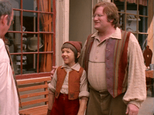 Geppetto takes Pinocchio around the town,introducing the residents to his son