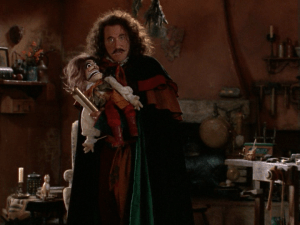 Stromboli appears in Geppetto's workshop, waiting to stake his claim to Pinocchio