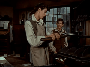 Tremain (R) goes to see Paul Revere for help, finding him at the printing press where his friend Silsbee works