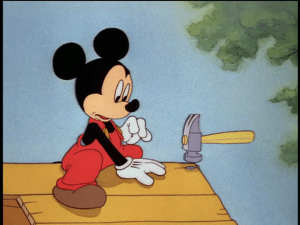 Mickey watches as the hammer starts working by itself to build the doghouse