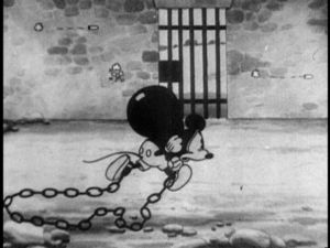 Mickey grabs his ball and chain and tries to escape amongst the confusion of the riot