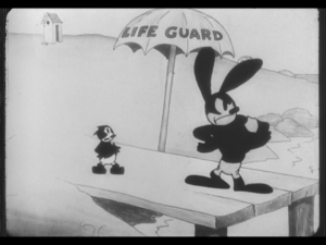 Oswald stands proudly with his lifeguard badge, while a nearby child nervously tries to ask him for help