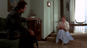 Patricia asks Lorton several questions about his line of work, including why he would want to kill her