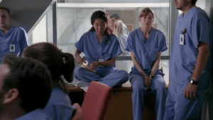 Cristina is seen suturing a banana while they all wait to find why they've been gathered