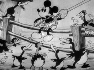 Mickey starts playing a tune for the barnyard musical extravaganza