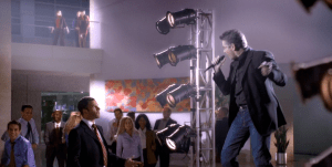 Eli thinks an impromptu George Michael concert is being held in the lobby of his firm, unaware that it is a hallucination